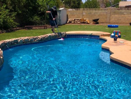A Group Of People Swimming In A Pool Of Water