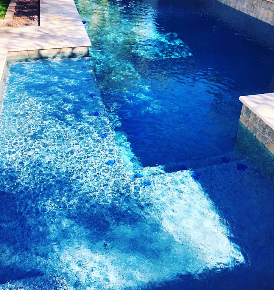 a pool next to a body of water